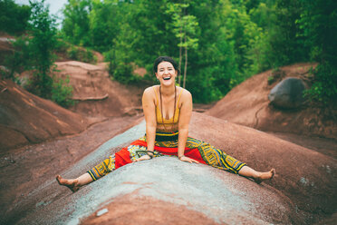 Woman sitting with legs apart on rock - ISF21149