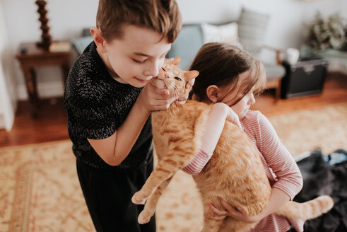 Children playing with cat at home - ISF21195