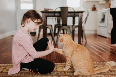 Girl playing with cat at home - ISF21199