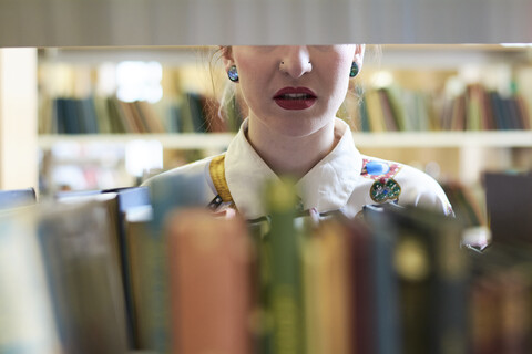 Studentin in einer öffentlichen Bibliothek, rote Lippen, lizenzfreies Stockfoto