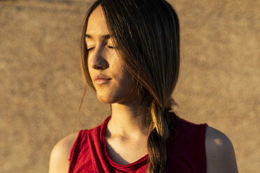 Portrait of teenage girl with closed eyes in sunlight - ERRF00944