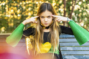 Girl posing in super heroine costume on a bench - ERRF01025
