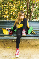 Girl in super heroine costume sitting on a bench - ERRF01026