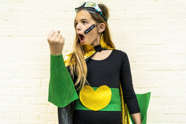 Girl in super heroine costume with band-aid on cheek - ERRF01048