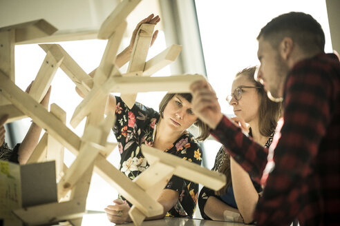 Group of creative professionals building wood object for a project - MJRF00157