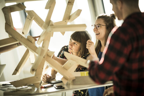 Group of creative professionals building wood object for a project - MJRF00195