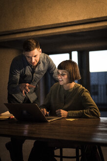 Colleagues sitting in office, working late - MJRF00207