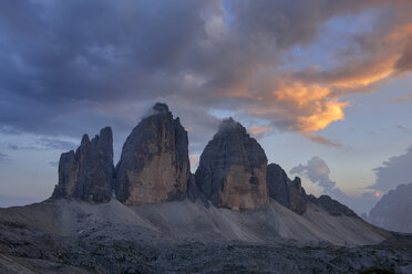 Italy, Sexten Dolomites, Tre Cime di Lavaredo at sunset, Nature Park Tre Cime, Unesco World Heritage Natural Site - RUEF02137