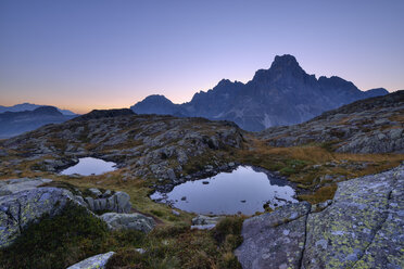 Italy, Dolomites, Pale di San Martino Mountain group with mountain peak Cimon della Pala and two small mountain lakes at sunrise - RUEF02159