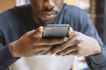 Man's hands holding smartphone, close-up - OCMF00404