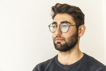 Portrait of pensive young man with beard and glasses - TCF06079