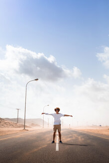 Sultanate Of Oman, Ras al Hadd, Desert road, Man standing in a sand storm - WVF01130