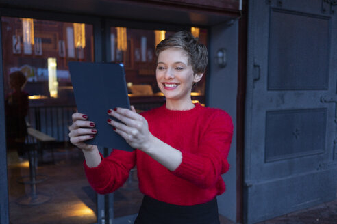 Portrait of smiling businesswoman taking selfie with digital tablet outdoors - TAMF01280