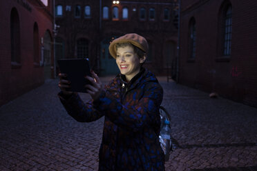 Deutschland, Berlin, Porträt eines glücklichen Touristen, der ein Selfie mit einem digitalen Tablet macht - TAMF01284