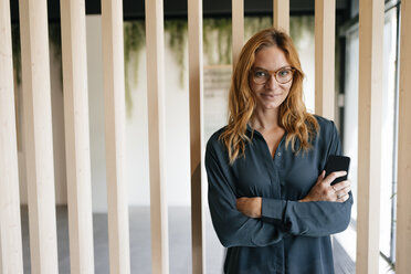 Portrait of confident businesswoman holding cell phone - GUSF01864