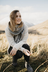 UK, Scotland, Loch Lomond and the Trossachs National Park, portrait of smiling young woman in rural landscape - LHPF00568