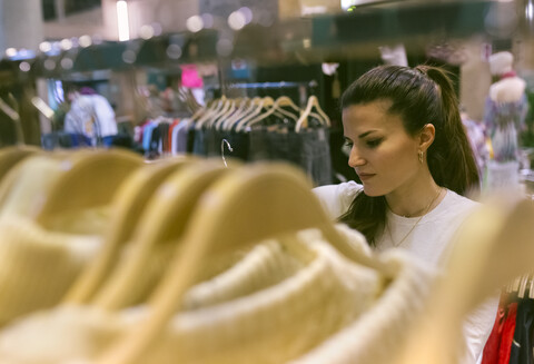 Woman shopping for clothes in a vintage boutique stock photo