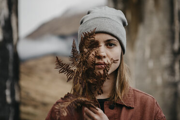 UK, Scotland, Highland, portrait of young woman holding fern - LHPF00606