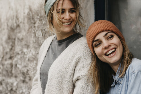 UK, Scotland, two laughing young women at a building - LHPF00631