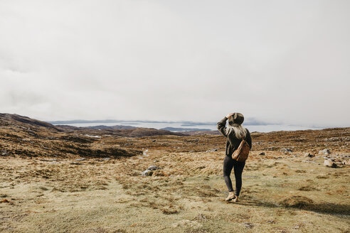 UK, Scotland, Highland, Applecross, rear view of young woman in rural landscape - LHPF00642