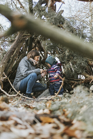 Mutter mit kleiner Tochter in einem Unterstand im Wald, lizenzfreies Stockfoto