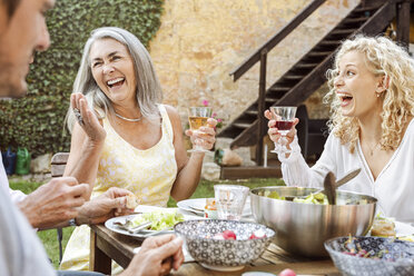 Happy family eating together in the garden - PESF01643