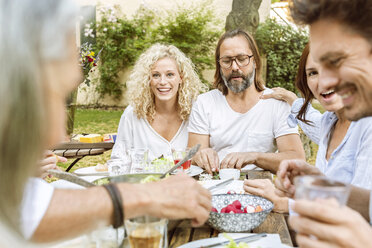 Happy family eating together in the garden - PESF01649