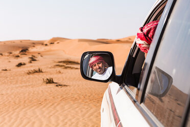 Bedouin looking in his car mirror, Sultanate Of Oman, Wahiba Sands - WVF01305