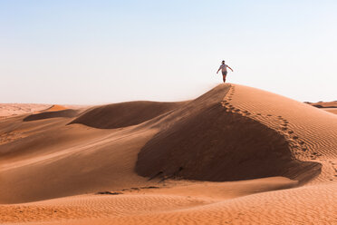 Man walking on a sand dune, Wahiba Sands, Oman - WVF01348