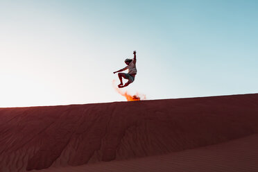 Sultanate Of Oman, Wahiba Sands, Mid adult man is playing with sand in the desert - WVF01397