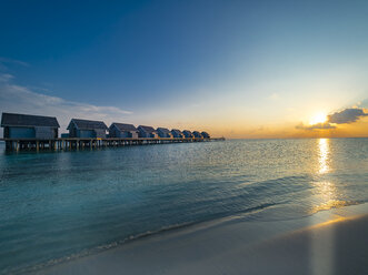 Maledives, Ross Atoll, water bungalows at sunset - AMF06906