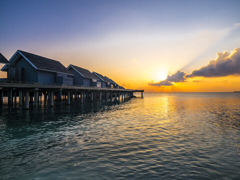 Maledives, Ross Atoll, water bungalows at sunset stock photo