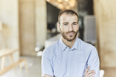 Portrait of serious businessman in modern office - FMKF05589