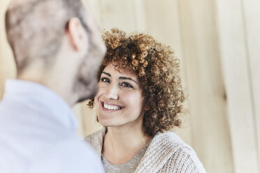 Portrait of smiling woman looking at man - FMKF05597