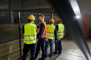 Rear view of workers standing in factory workshop - ZEDF02081