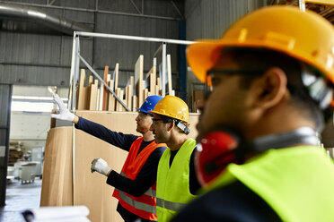 Workers talking in factory workshop - ZEDF02185