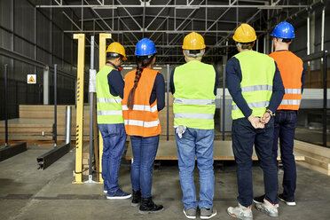 Rear view of workers standing in factory workshop - ZEDF02189