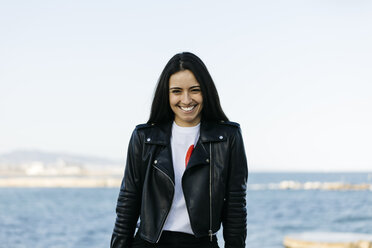 Portrait of happy young woman, sea in the background - JRFF03115