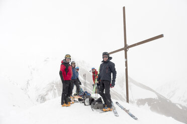 Georgia, Caucasus, Gudauri, peeope at summit cross on a ski tour - ALRF01505