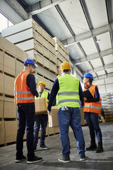 Workers talking in factory warehouse - ZEDF02272