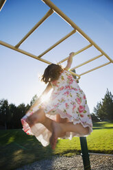 Asian girl hanging on play structure - BLEF00009