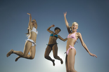 Multi-ethnic women in bathing suits jumping - BLEF00015