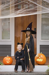 Mixed race young girls in cat and witch costumes - BLEF00062