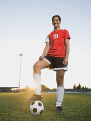 Mixed race woman posing with soccer ball - BLEF00067