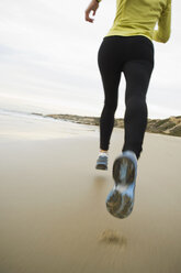 Hispanic woman running on beach - BLEF00069