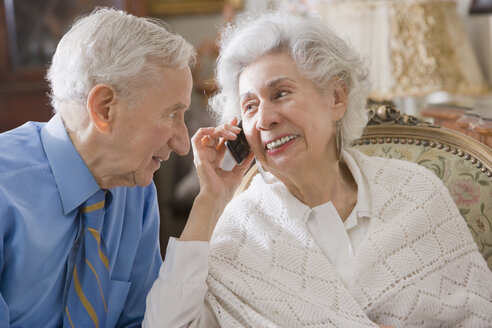 Älteres hispanisches Paar, das ein Mobiltelefon benutzt - BLEF00083