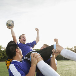 Soccer players lifting teammate and cheering - BLEF00118