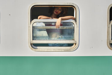 Woman looking out of train window - VEGF00043