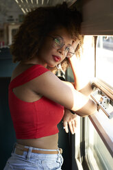 Young woman on a train looking out of window - VEGF00052