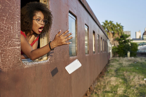 Woman's phone falling out of train window - VEGF00067